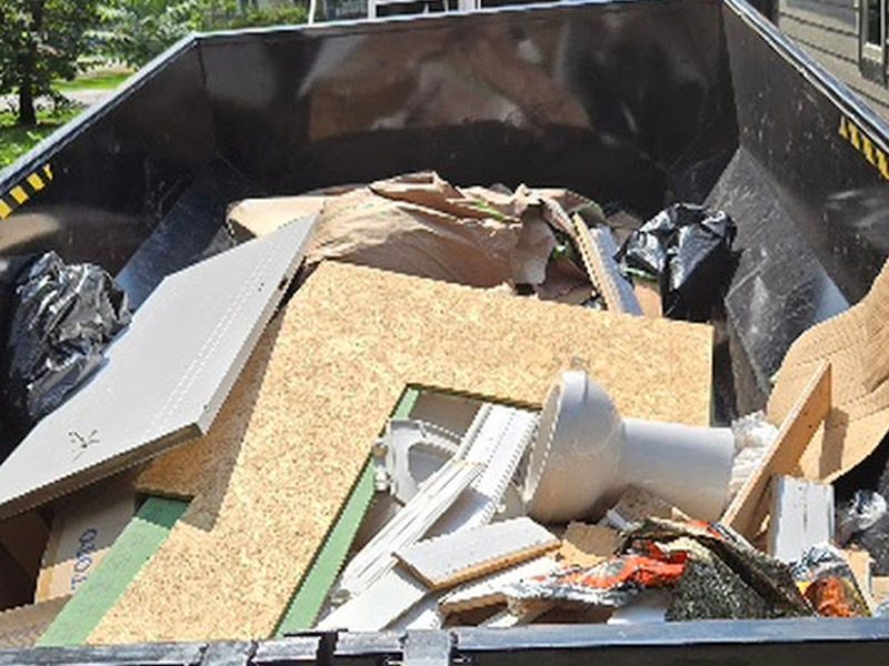 Dumpster loaded with remodel and construction debris