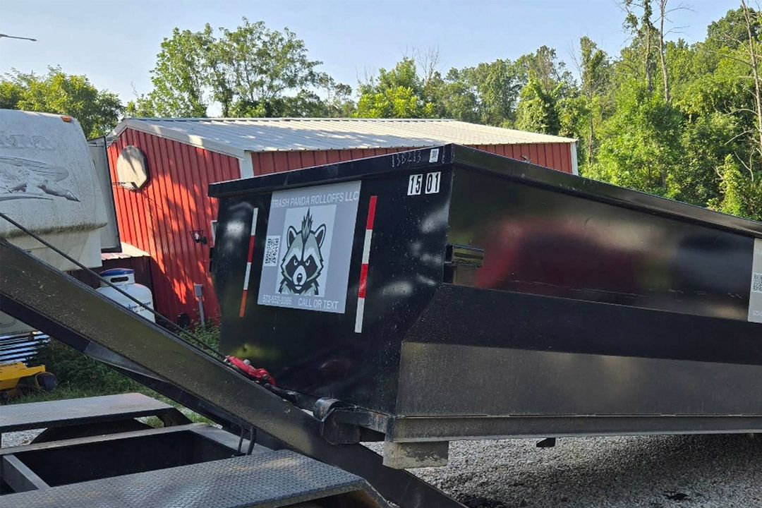 Trash Panda roll-off dumpster with company logo decal