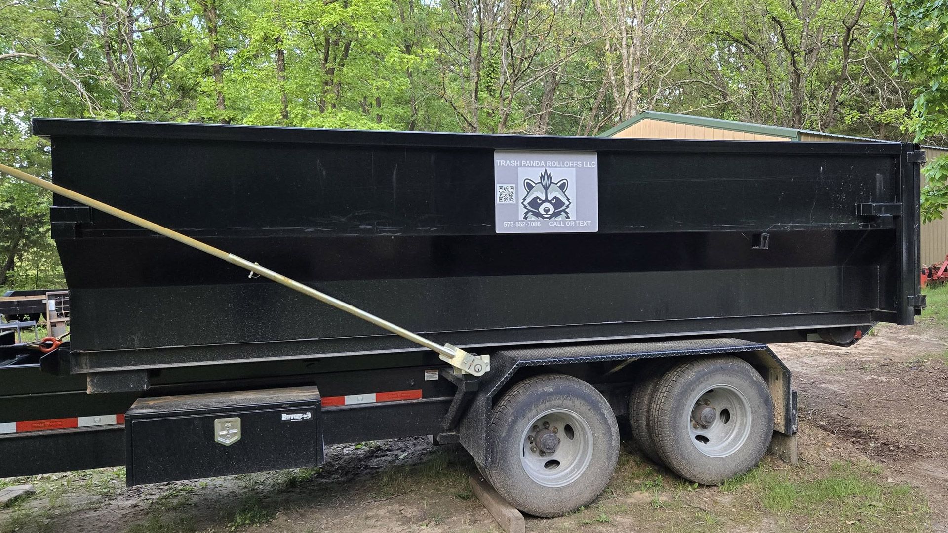 Trash Panda Rolloffs roll-off dumpster loaded on a trailer