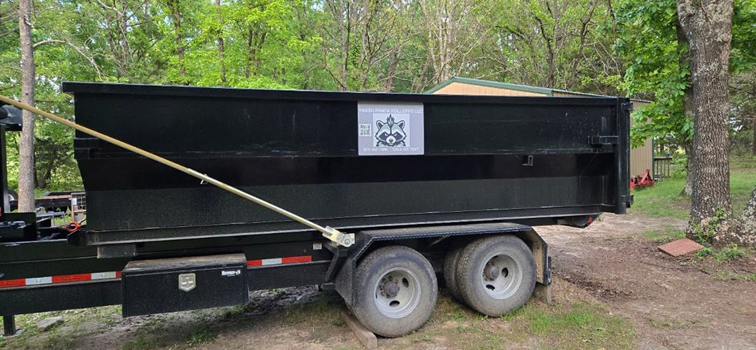 Roll-off dumpster on a trailer ready for delivery